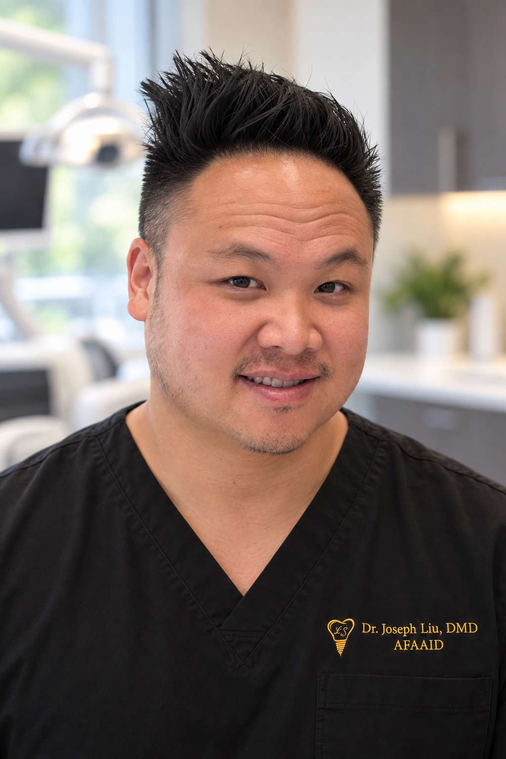 Dr. Joseph Liu smiling in black scrubs